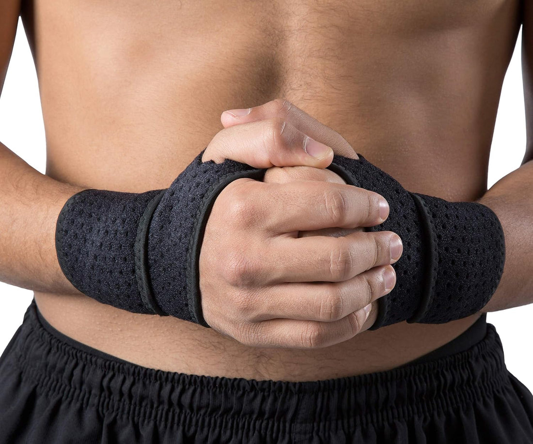 Black wrist support brace on a person's wrist with a white background